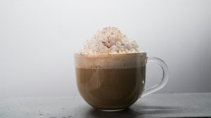 Hot chocolate with whipped cream in a glass cup